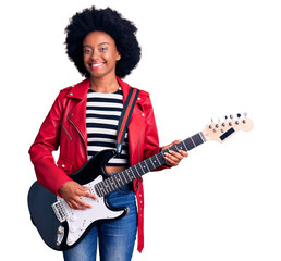 Wall Mural - Young african american woman playing electric guitar looking positive and happy standing and smiling with a confident smile showing teeth