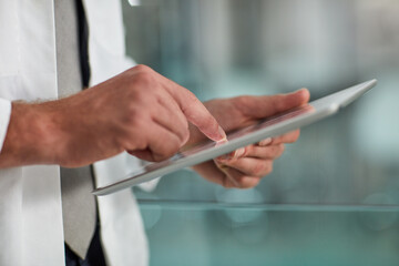 Fototapete - Tracking a patients progress. Closeup shot of an unrecognisable doctor using a digital tablet.