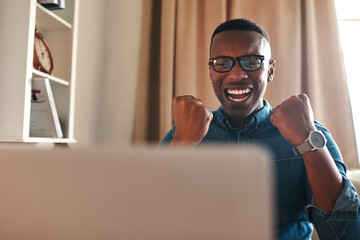 Poster - This is the best news ever. Cropped shot of a handsome young businessman sitting alone in his home office and feeling excited while using his laptop.