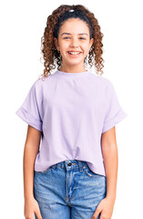 Wall Mural - Beautiful kid girl with curly hair wearing casual clothes with a happy and cool smile on face. lucky person.