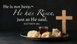 Text HE IS NOT HERE. HE IS RISEN, JUST AS HE SAID with glass of wine, bread and cross on dark background