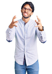 Poster - Handsome hispanic man wearing business shirt and glasses shouting frustrated with rage, hands trying to strangle, yelling mad