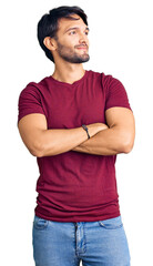 Poster - Handsome hispanic man wearing casual clothes looking to the side with arms crossed convinced and confident