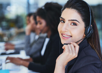 Sticker - We care highly about every customer. Portrait of a young woman working in a call centre.