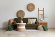 Interior of living room with green sofa, rattan poufs and vases