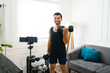 © AntonioDiaz - Cheerful fitness blogger filming a video while exercising