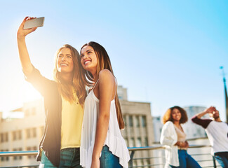 Aufkleber - Together with each other is our favourite place to be. Shot of young female friends taking a selfie outside.