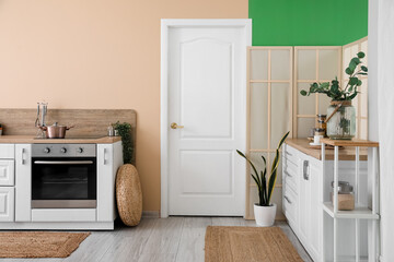 Sticker - Interior of modern kitchen with white counters and electric oven