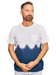 Poster - Handsome middle age man wearing casual tie dye tshirt smiling looking to the side and staring away thinking.