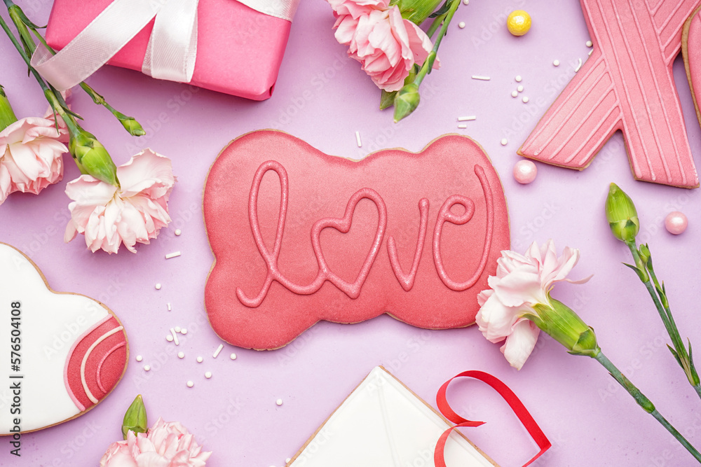 Composition with sweet cookies and beautiful carnation flowers on lilac background. Valentine's Day celebration