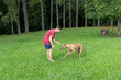© emanuel nyszczuk - hombre joven, caucasico, con un perro galgo, disfrutando al aire libre.