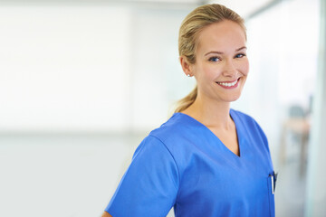 Wall Mural - Medicine is her calling. Portrait of a confident young doctor wearing blue scrubs.