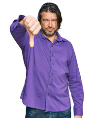 Wall Mural - Middle age handsome man wearing business shirt looking unhappy and angry showing rejection and negative with thumbs down gesture. bad expression.