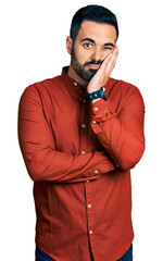 Sticker - Young hispanic man with beard wearing casual shirt thinking looking tired and bored with depression problems with crossed arms.