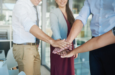 Wall Mural - To win, youve gotta go all in. Shot of a group of colleagues joining their hands together in solidarity.