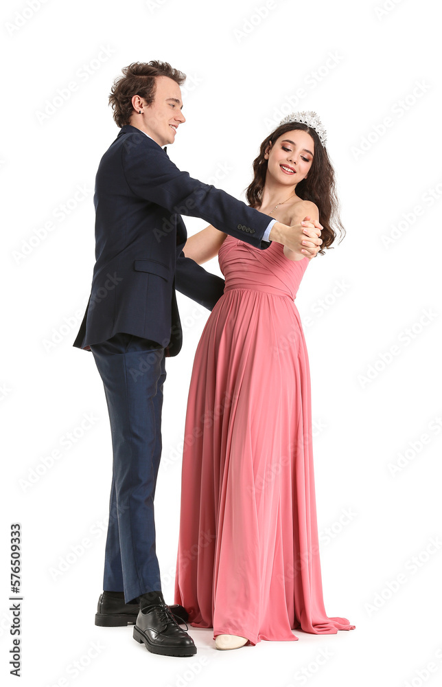 Beautiful couple dressed for prom dancing on white background