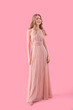 © Pixel-Shot - Teenage girl in prom dress on pink background