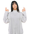 © Krakenimages.com - Young brunette woman with bangs wearing casual turtleneck sweater relax and smiling with eyes closed doing meditation gesture with fingers. yoga concept.
