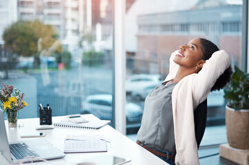 Aufkleber - More success, less stress. Shot of a young businesswoman relaxing at her desk in a modern office.