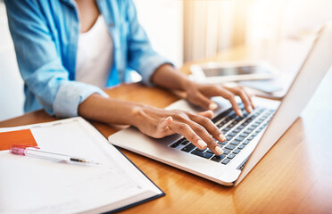 Sticker - You can do anything online, believe me. Shot of an unrecognizable young woman working on her laptop at home.