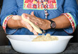 woman making corn tortillas with her hands