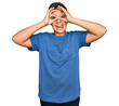 © Krakenimages.com - Teenager hispanic boy wearing casual clothes doing ok gesture like binoculars sticking tongue out, eyes looking through fingers. crazy expression.