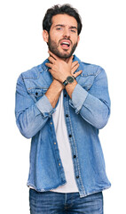 Sticker - Young hispanic man wearing casual clothes shouting suffocate because painful strangle. health problem. asphyxiate and suicide concept.