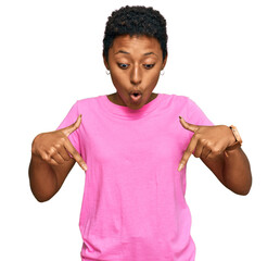 Canvas Print - Young african american woman wearing casual clothes pointing down with fingers showing advertisement, surprised face and open mouth