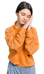 Poster - Young brunette girl with long hair wearing sweatshirt and headphones sleeping tired dreaming and posing with hands together while smiling with closed eyes.