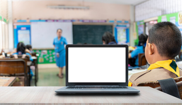 Background image of opened laptop with blank white screen on teachers desk in school auditorium, copy space