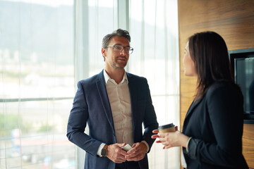 Poster - Hes always interested in what she has to say. Shot of two businesspeople talking in a corporate office.