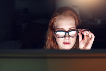 Poster - This could be the answer Ive been looking for. Shot of a young businesswoman working late in her office.