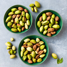 Roasted Pistachio Nuts In A Bowl On The Table, Against A White Background. Nut, Snack, Dining Concept Created With Generative AI.
