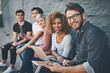 © Camerene Pendl/peopleimages.com - The social networking row. Shot of a diverse group of people social networking outside.