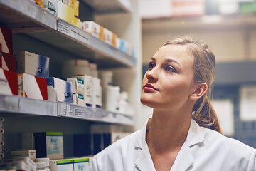 Poster - Its my true calling to work as a pharmacist. Shot of an attractive young woman working in a pharmacy.