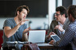 © Yuri A/peopleimages.com - Im thinking about this big.... Cropped shot of three businessman discussing work in the office.