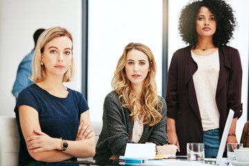 Poster - Serious about our work ethic. Portrait of a group of young businesswomen having a meeting at work.