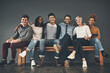 © Camerene Pendl/peopleimages.com - Colleagues that have become friends. Studio shot of a diverse group of creative employees embracing each other against a grey background.