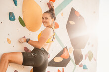 Climber Wearing In Climbing Equipment. Practicing Rock-climbing On A Rock Wall Outdoor. Xtreme Sports And Bouldering Concept.  Rock Climber Climbs On A Rocky Wall.