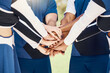 Hands, teamwork and motivation with cheerleaders in a huddle for support during a sports game or competition. Training, event and a group of cheerleading women in a circle for a performance