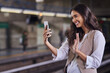© Arnell K./peopleimages.com - Saying hello to the people at home. Cropped shot of a young attractive woman video calling with her cellphone while commuting with the train.