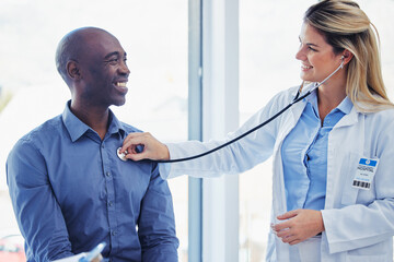 Canvas Print - Doctor woman, patient and consultation with stethoscope in hospital for healthcare or health insurance. Black man and cardiologist person talking about lungs, breathing and advice for healthy heart