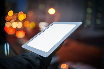 Poster - Switched on to business. Cropped shot of a businessman using a digital tablet at night.