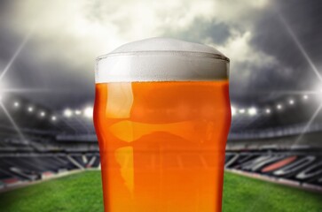 Wall Mural - Foamy chill beer on football stadium background