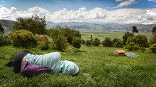 A Young Woman Rests While Taking In The View Of One Stretch Of The Sacred Valley Near Pisac, Peru.