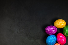 Stylish Background With Colorful Painted Easter Eggs Isolated On Dark Concrete Background For Web Design. Flat Lay, Top View, Mockup, Overhead Copy Space Happy Easter Concept