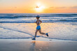 © Cavan Images - Woman jogging on beach at sunrise, Noosa Heads, Queensland, Australia