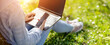 © candy1812 - Woman with laptop sitting on the grass in the natural park.