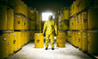 storage of metal barrels toxic waste and man in protective suit