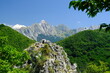 Mountains panorama. Panorama of mountains. Pizzo d'Uccello, Monte Sagro and the Apuan Alps between green woods and blue sky. Apuan Alps, Tuscany, Italy. 